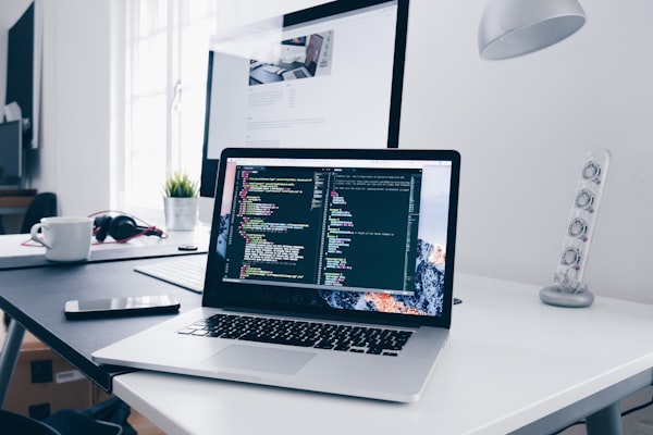 Web development workspace with multiple screens and code